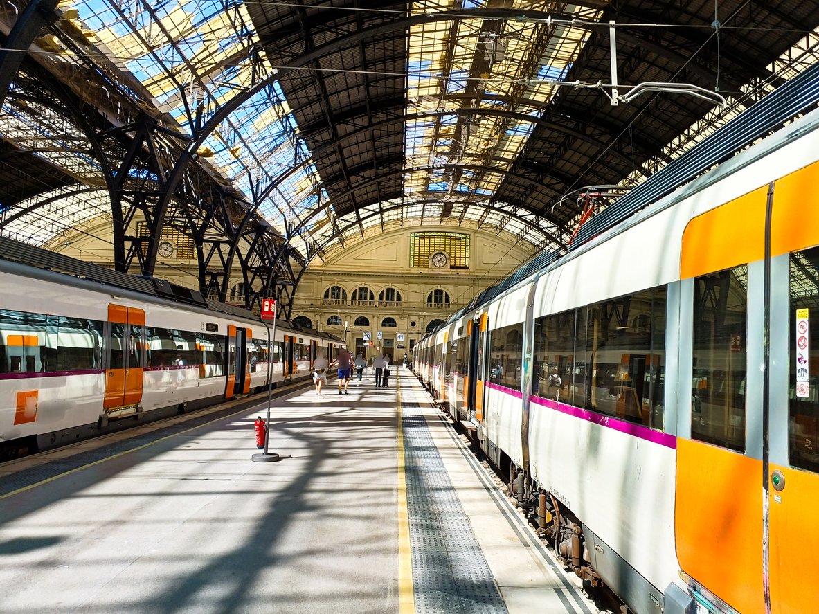 Train station in Barcelona with two trains waiting