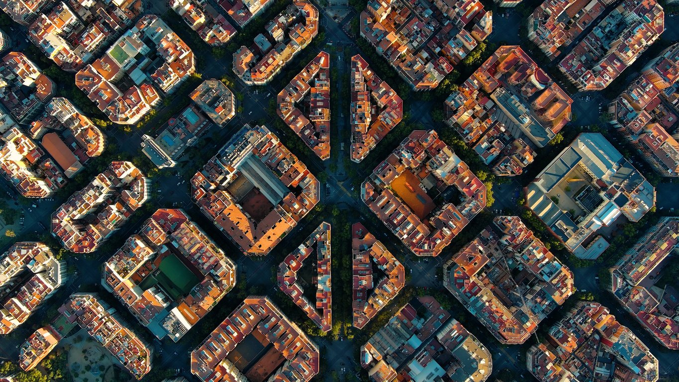 Aerial view of the Eixample district in Barcelona, showcasing the unique grid pattern and octagonal city blocks.